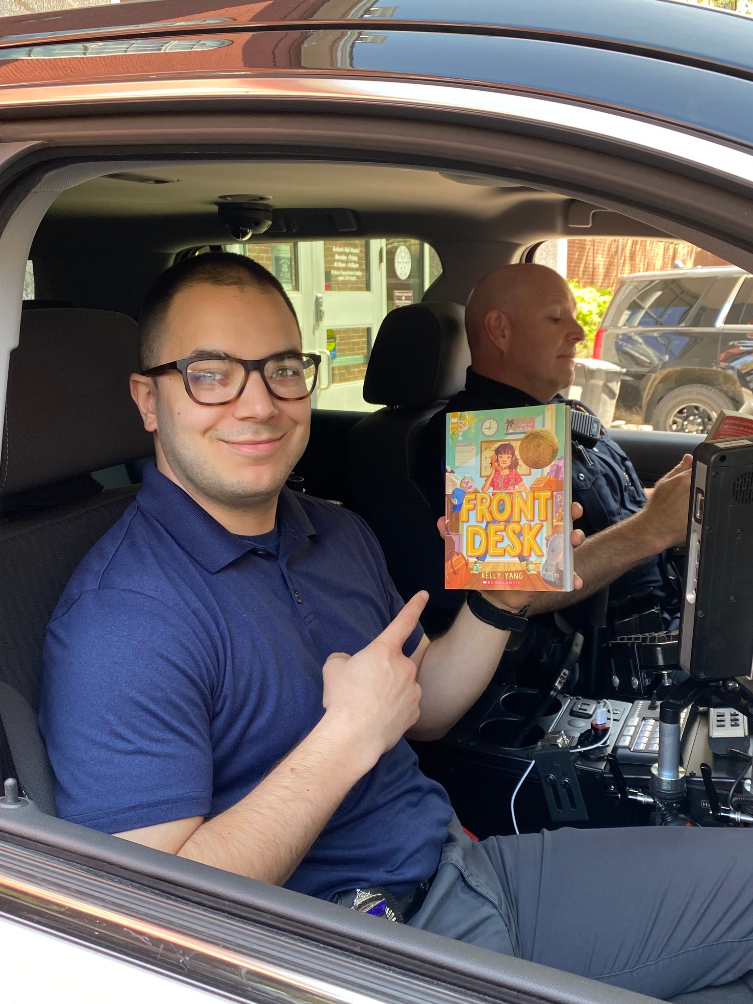 AFD 2022 - Holding book in police car