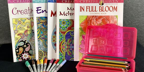 Assorted coloring books, pens, markers, and colored pencils