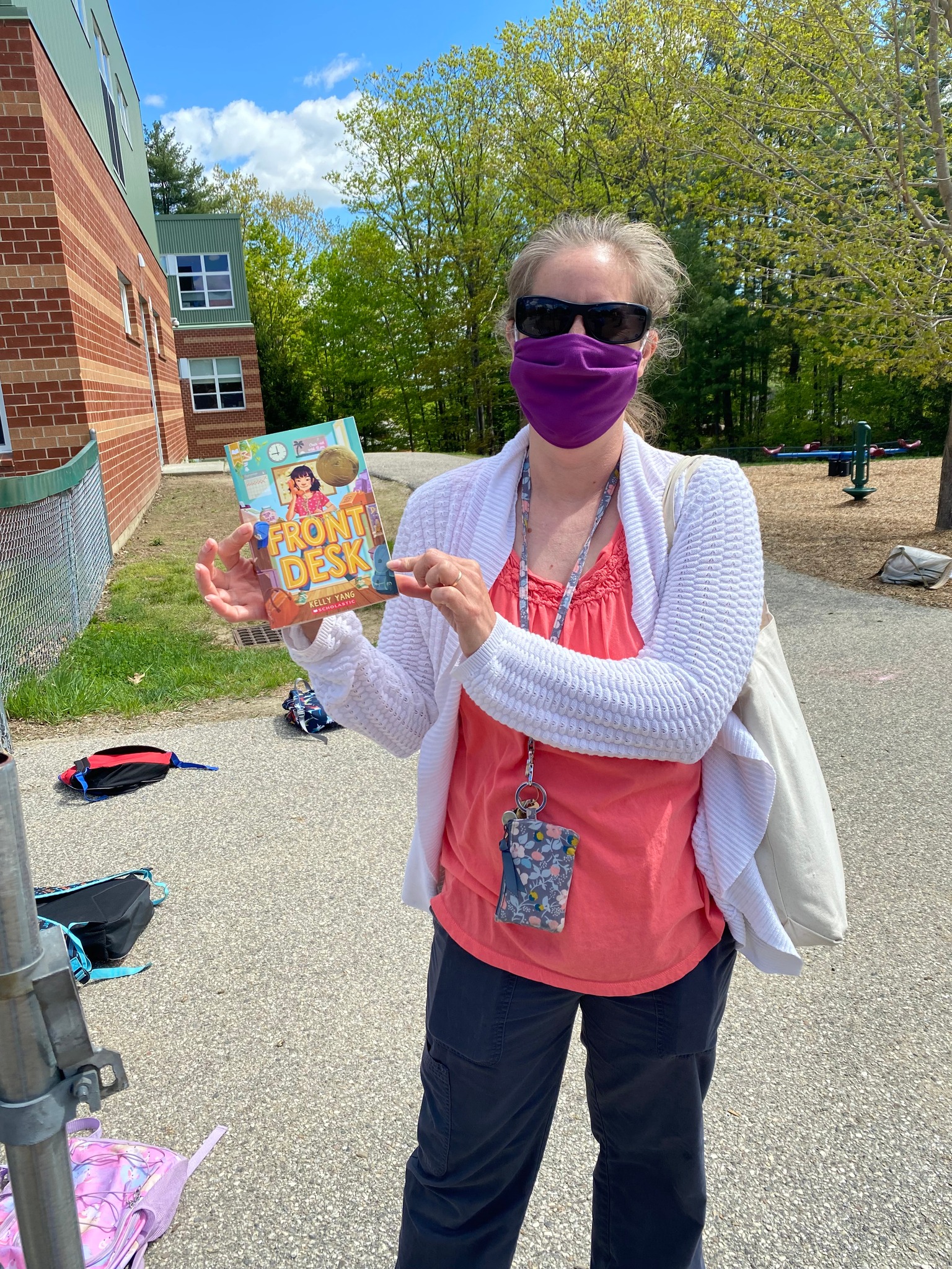 Woman holding Front Desk book in front of library