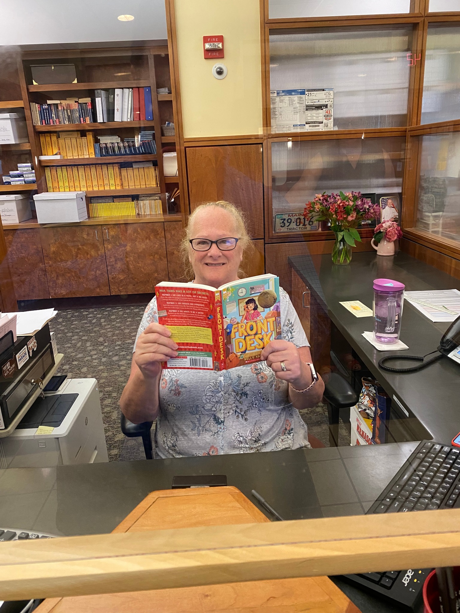 AFD 2022 - reading book at library circulation desk
