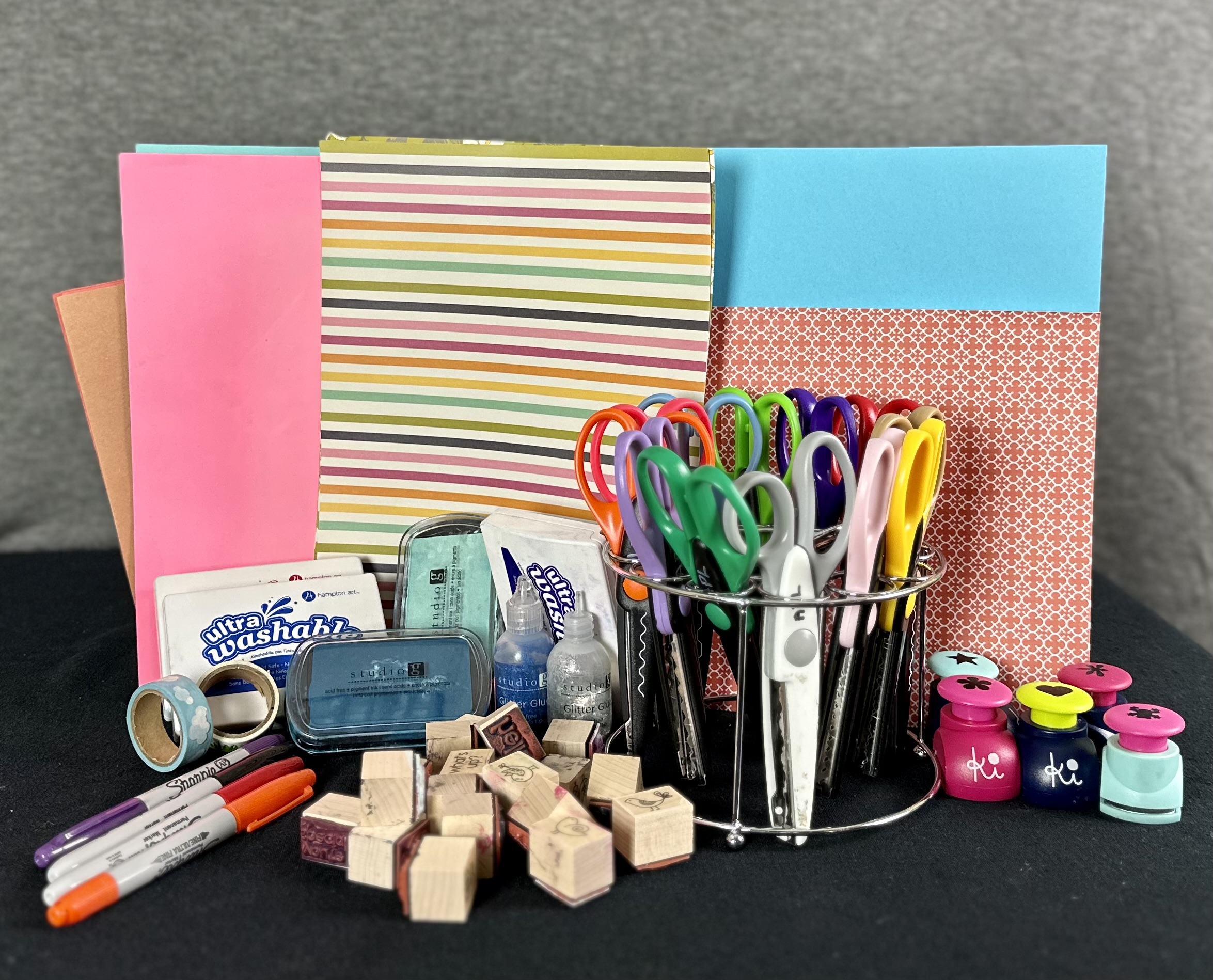 Assorted paper, scissors, stamps, and cutout stamps