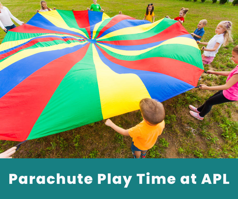 Kids playing with parachute on grass