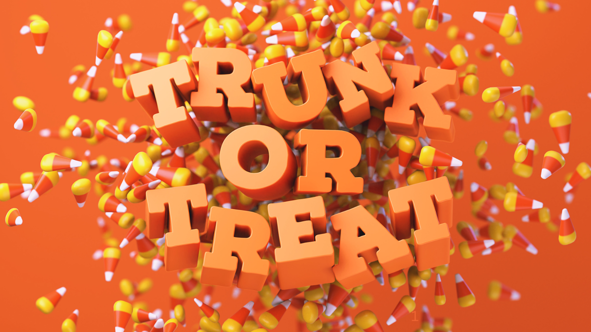 trunk or treat text in orange with candy corn behind it 