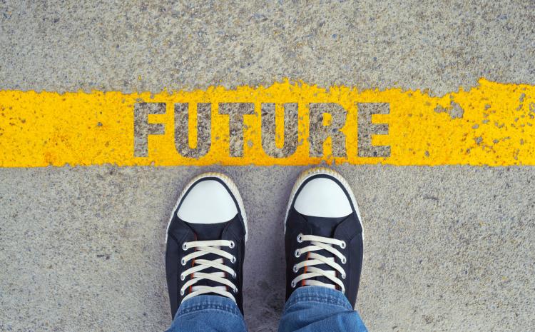 Two shoes in front of the word Future surrounded by yellow paint