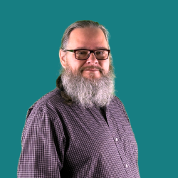 Greg Staff photo with teal background
